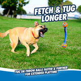 A tan dog with a red collar leaps joyfully on a grassy field, aiming mid-air for the durable fetch toy—Chuckit Ultra Duo Tug. The text reads, Fetch & Tug Longer: Throw or tug balls faster and further for extended playtime.
