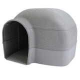 The Petmate Husky Dog House is a large, igloo-shaped shelter in light gray with an arched entrance, smooth surface, and textured base. It features a sturdy, elevated floor designed by Petmate for outdoor use.