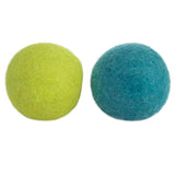 On a plain white background, two Mad Cat Wacky Wool Balls, one lime green and one teal, exhibit a fuzzy texture and are infused with catnip.