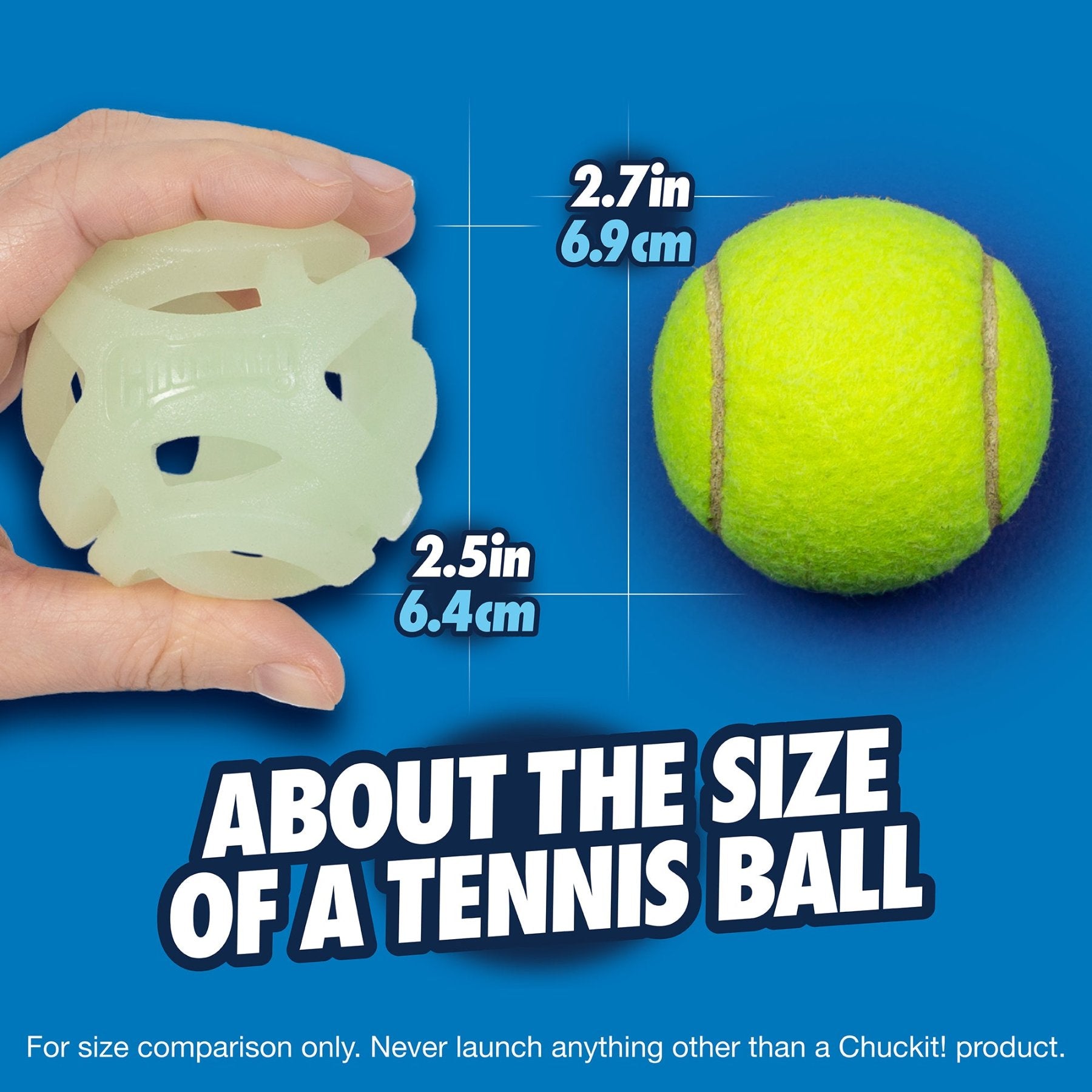 A hand holds a Chuckit! Max Glow Air Fetch Ball beside a yellow tennis ball on a blue background. Text states, About the size of a tennis ball, showing measurements: 2.5 in (6.4 cm) for the glow toy and 2.7 in (6.9 cm) for the fetch ball, both by Chuckit.