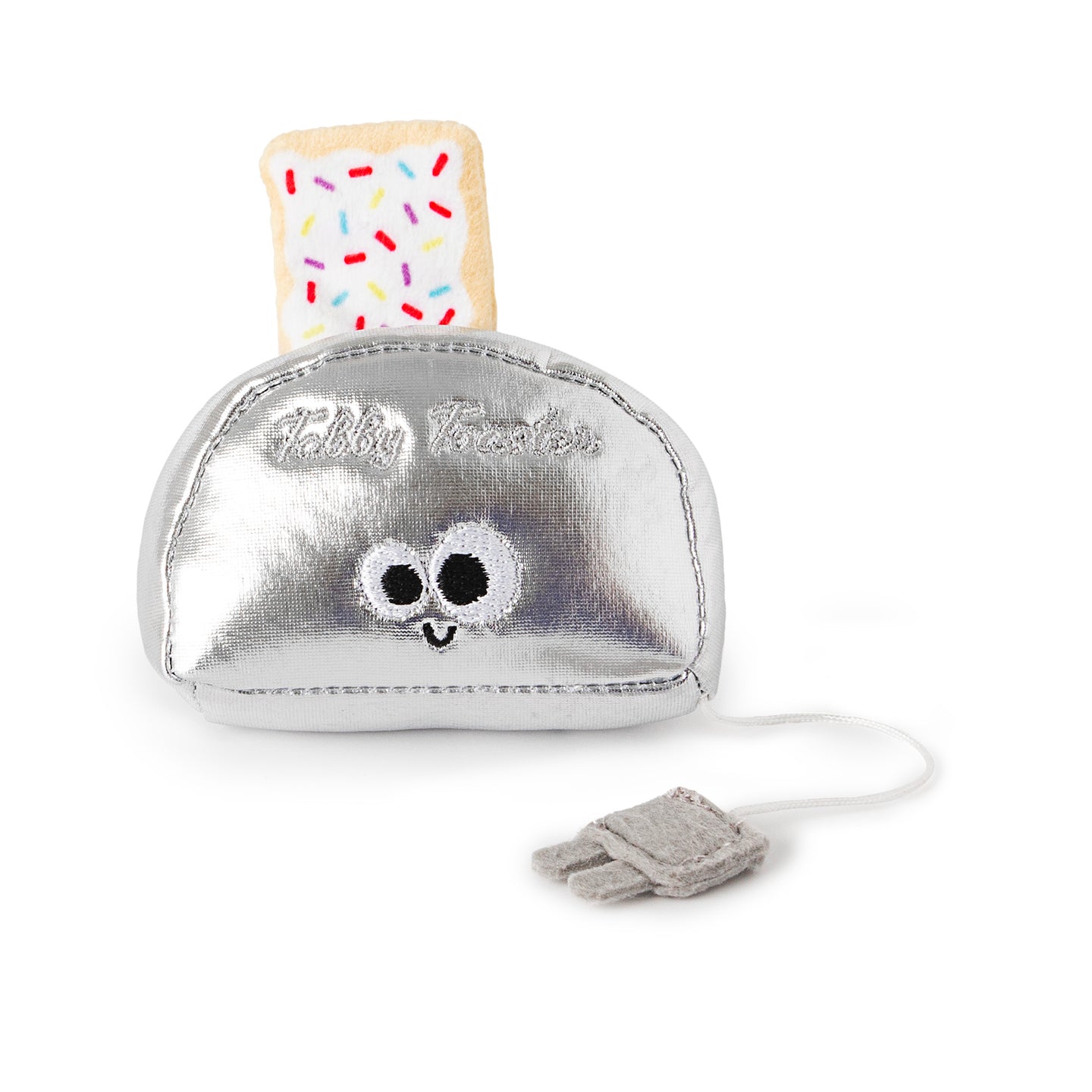 Meet the Mad Cat Buzzing For Breakfast Cat Toy: a charming silver plush toaster with embroidered eyes and a smile. A sprinkle-adorned pastry pops out, complemented by a gray plug-tipped power cord and Baby Toaster elegantly embroidered on the side.