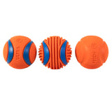 Two Rugged Balls with blue accents are placed on the left and right, while a cylindrical piece from the Chuckit! Fetch Medley Gen 3 with ribbed blue sections is in the center, forming a neat row of three orange dog toys.