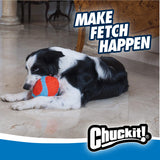 A black and white dog relaxes on a marble floor, resting its head on the Chuckit! Indoor Fumbler, an ideal dog toy for fetch indoors. The backdrop displays Make Fetch Happen, with the Chuckit! logo at the bottom.