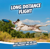 A dog jumps mid-air to snag a glow-in-the-dark Chuckit! Paraflight Max Glow Flyer against bushes and a blue sky with fluffy clouds. White text: Long Distance Flight, Flies Through the Air for Easy Tracking and Catching, ideal for fetch toy fans. Brand: Chuckit.