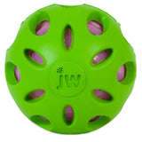 A JW Crackle Heads Crackle Ball dog toy by Jw is green with circular cutouts and a visible pink interior. The outer surface displays jw at the center, enhancing interactive play by allowing the inner layer to be visible through the openings.