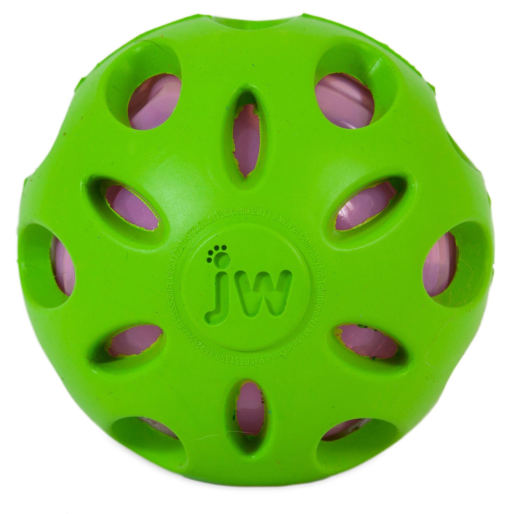 A JW Crackle Heads Crackle Ball dog toy by Jw is green with circular cutouts and a visible pink interior. The outer surface displays jw at the center, enhancing interactive play by allowing the inner layer to be visible through the openings.