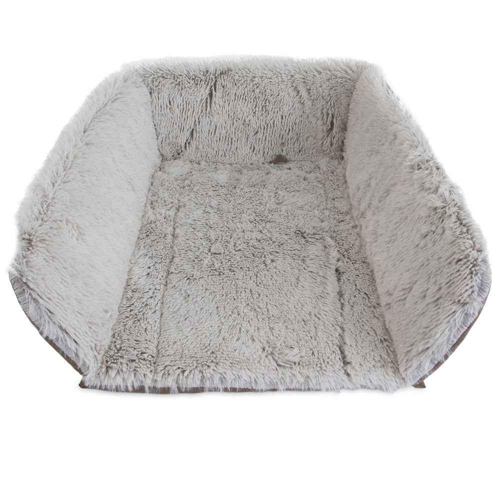 The Petmate Cozy Kennel Mat, by Petmate, is a large gray pet bed with plush interior and high soft sides. Its shaggy texture mimics faux fur for unrivaled comfort, resembling a cozy home. It sits invitingly empty against a white background.