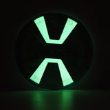 The Chuckit! Paraflight Max Glow Flyer Dog Toy is a glowing green and black circular accessory with an X-shaped center, emitting vivid light against the dark—a perfect choice for exciting nights of play.