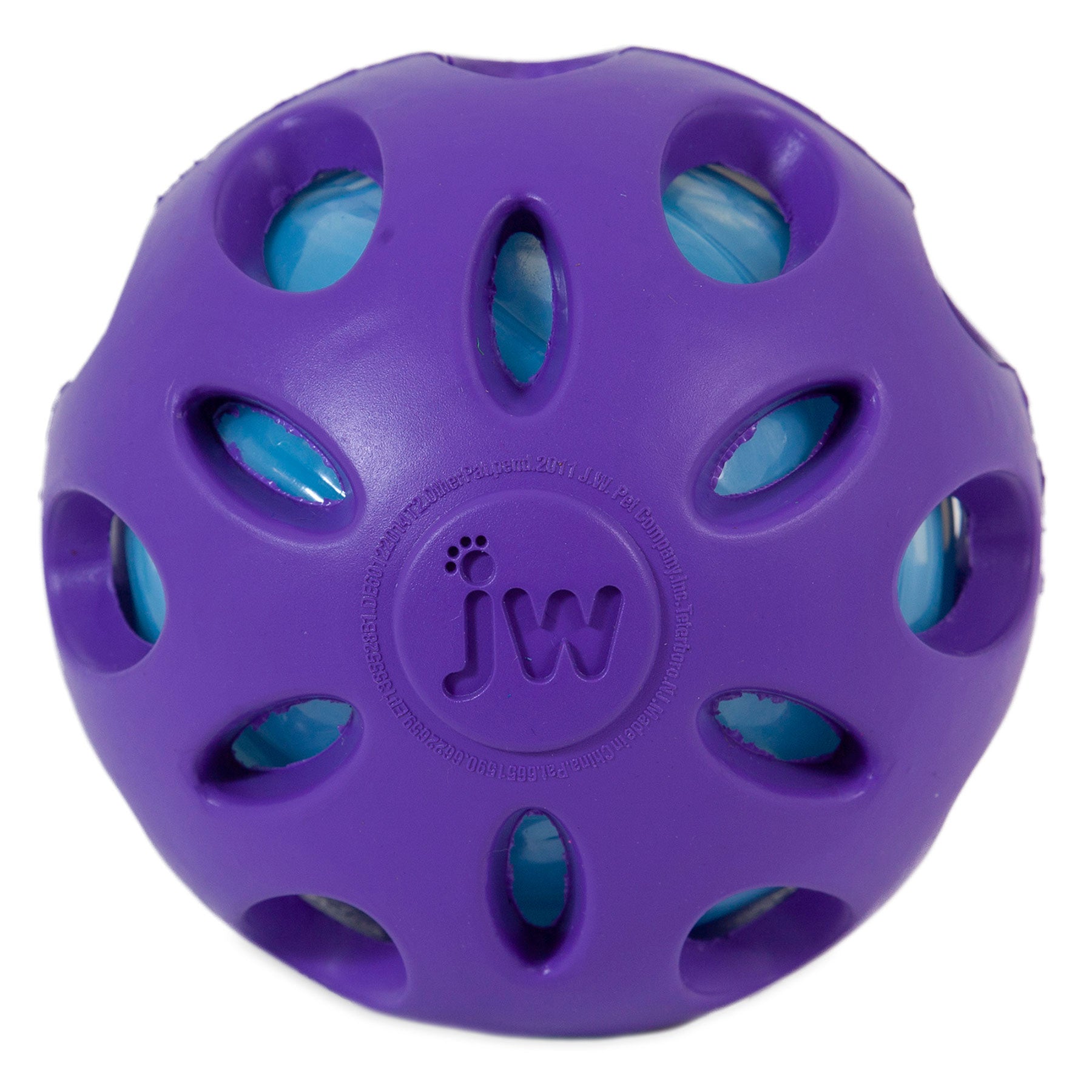 The JW Crackle Heads Crackle Ball Dog Toy by Jw features a purple rubber exterior with circular cutouts revealing a blue layer underneath. This embossed jw toy has a textured, geometric design making it perfect for interactive playtime with pets.