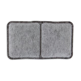 The Aspen Pet product resembles a rectangular gray felt coaster with black stitching, divided into two square sections, reminiscent of charcoal filters.