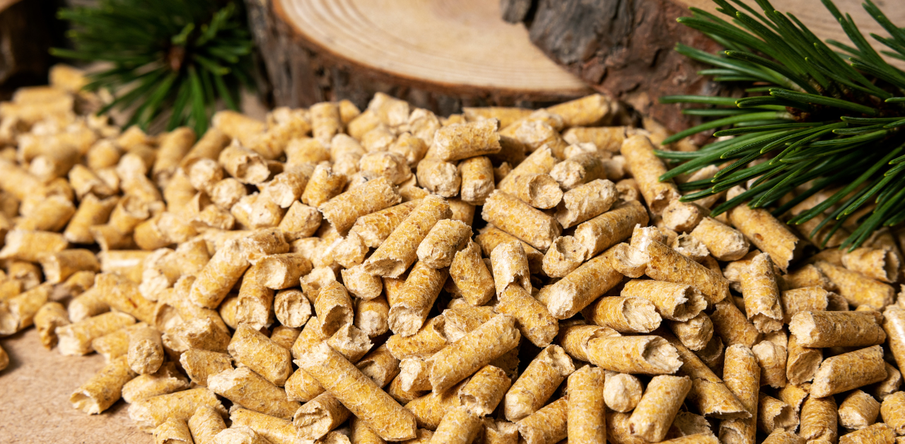 Pile of natural wood pellets on a rustic surface, commonly used as eco-friendly cat litter or animal bedding