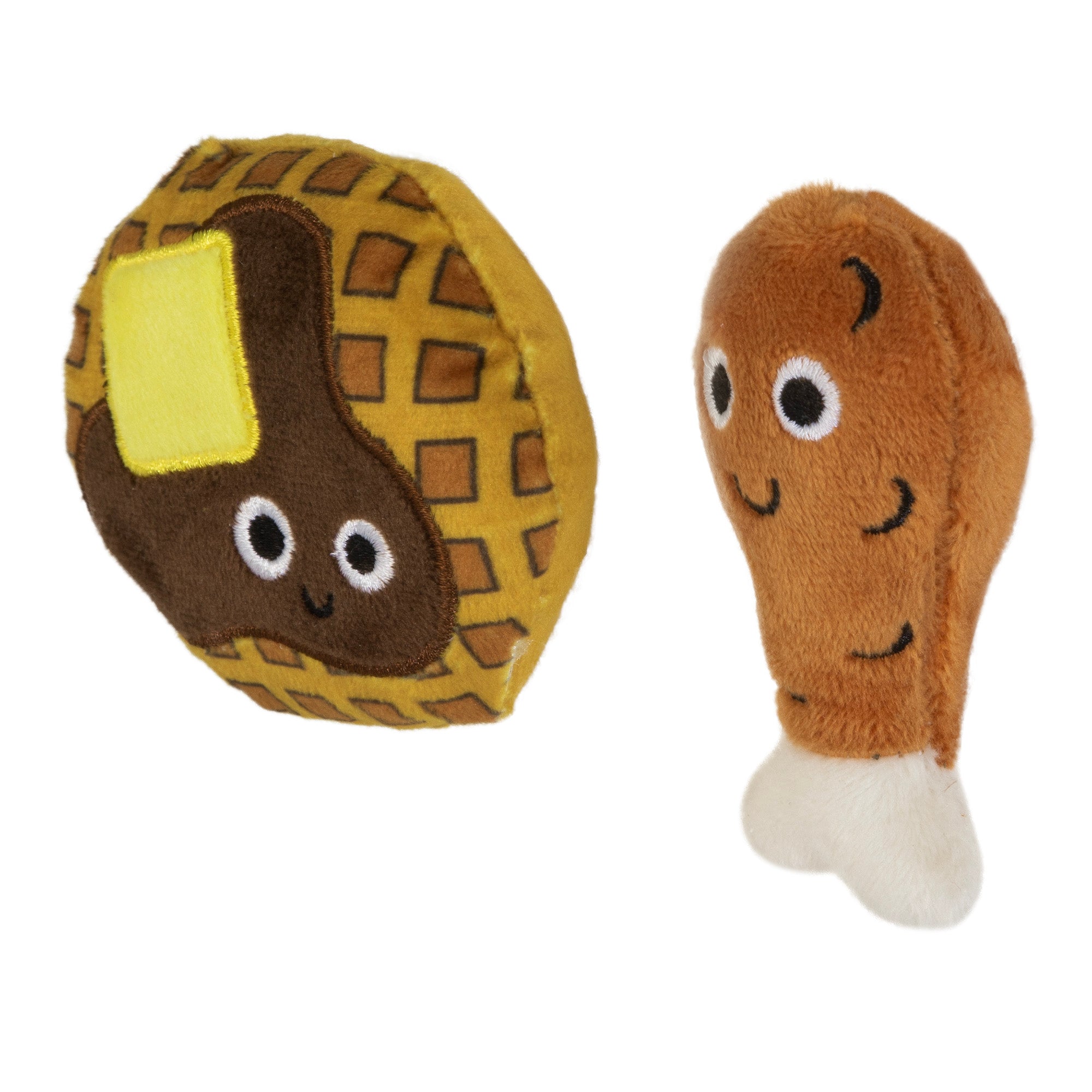 The Mad Cat Chicken and Waffles Twin Pack Catnip & Silvervine Cat Toy features plush toys shaped like a smiling waffle with butter and a chicken drumstick, both with large eyes. The waffle is round with a grid pattern, and the drumstick has a white bone end—perfect for playful cats.
