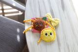 The Quirky Kitty Pasta Pals 3-Pack Cat Toy Set with Catnip features adorable plush cat toys in fun designs, shown here on a wooden table beside a red checkered pillow and yellow plush. A playful set from Quirky Kitty for your home.