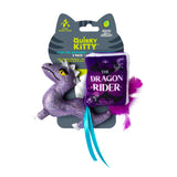 The Quirky Kitty Fairy Tail Romance 2pk Cat Toy Set with Catnip includes a sparkly purple dragon plush and a plush book labeled The Dragon Rider, both with purple feathers and blue ribbons. Brand: Quirky Kitty.
