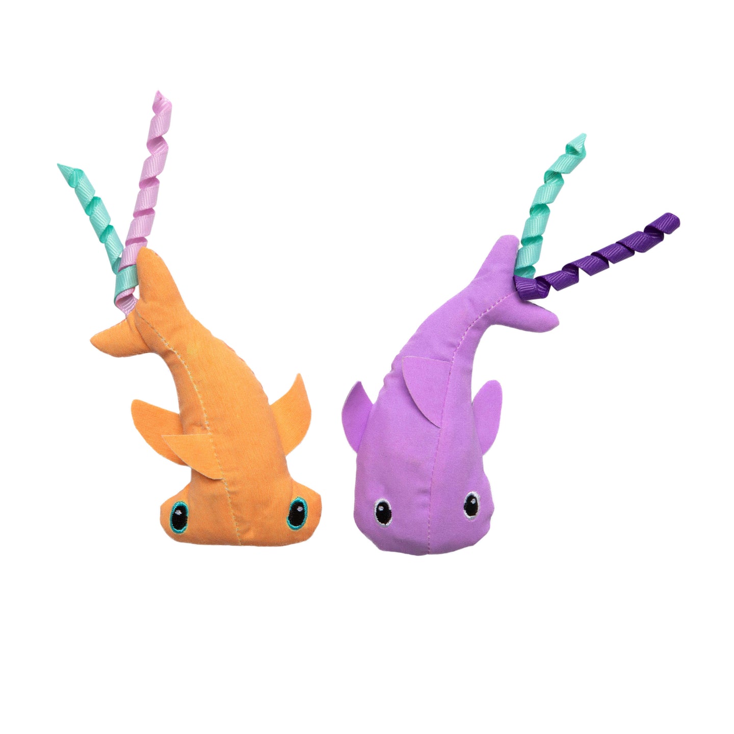 The Quirky Kitty Color Changing Shark 2pk by Quirky Kitty features two ocean-themed catnip toys—one orange with teal eyes and pink/teal ribbon, the other purple with black eyes and green/purple ribbon—perfect for playful cats.