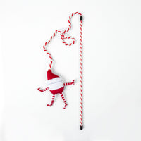 A Quirky Kitty® On Dancer On Prancer Wand cat toy featuring a red and white striped wand with a dangling plush Santa character.