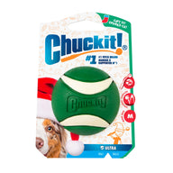 A festive green and white Chuckit!® Holiday Ultra Ball dog toy in packaging featuring a dog wearing a Santa hat.