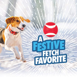 A dog runs through the snow next to a Chuckit!® Holiday Ultra Ball.