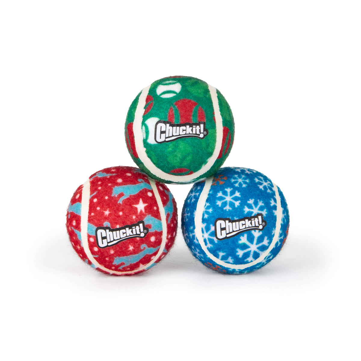 Three Chuckit!® Holiday Tennis Balls Dog Toy stacked in a pyramid, featuring red, green, and blue festive patterns with snowflakes and reindeer.