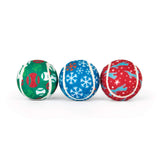 Three Chuckit!® Holiday Tennis Balls featuring green, blue, and red patterns of baseballs, snowflakes, and silhouettes of jumping dogs.