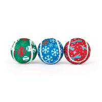 Three Chuckit!® Holiday Tennis Balls featuring green, blue, and red patterns of baseballs, snowflakes, and silhouettes of jumping dogs.