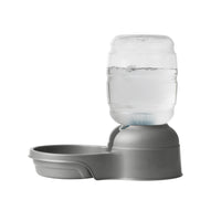 The Petmate Replendish Pet Waterer With Microban by Petmate is a gray automatic pet water dispenser with a clear bottle and filter, designed to keep your pet’s bowl refilled and water fresh. Shown on a white background.