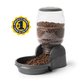 The Petmate Replendish Pet Feeder With Microban features a clear plastic top, a black base filled with brown kibble, antimicrobial protection, and a label stating "World's #1 Gravity Feeder, Made in the USA.