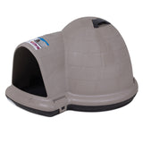 The Petmate Indigo Dog House by Petmate is a beige, igloo-shaped outdoor pet sanctuary with a black base and left-side entrance. It features a top handle and label with text and image, made from durable plastic, ideal for backyard settings.