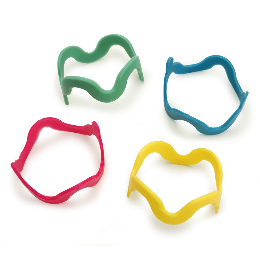 Four whimsically designed FAT CAT Cat Crazies cat toys by Fatcat in bright green, blue, yellow, and red mustache shapes are arranged on a white background.