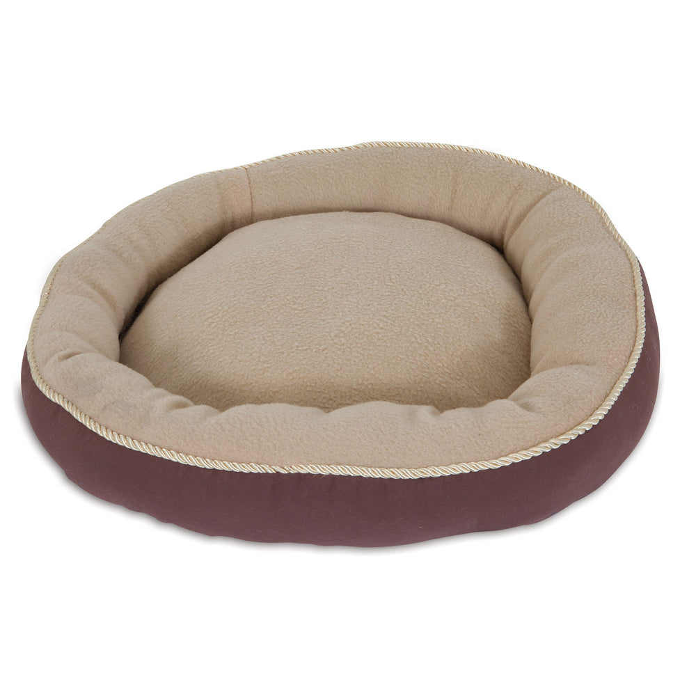 The Aspen Pet Round Pet Bed With Bolster & Gold Cord provides a cozy resting spot with its plush interior, soft cushioned border, and contrasting dark brown exterior. Its machine washable for easy care.
