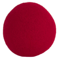 A bright red, textured JW Wool-ee Ball by Jw, resembling a fabric-covered sphere, is centered against a plain white background. This biodegradable toy doubles as an antimicrobial plaything, offering both fun and cleanliness.