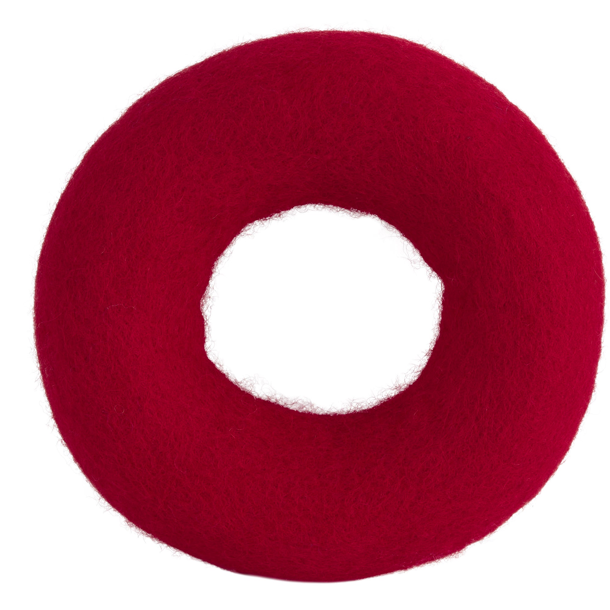 The JW Wool-ee Ring Dog Toy by Jw is a fuzzy, textured red doughnut-shaped toy made from natural wool, featuring a hollow center and set against a plain white background.