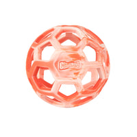 The Chuckit! Hol-ee Roller is a red and white rubber dog toy with a honeycomb pattern, open hexagonal holes, and the Chuckit! brand name displayed in the center.