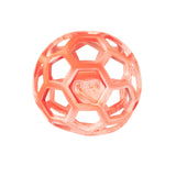 The Chuckit! Hol-ee Roller is a translucent orange rubber dog fetch toy with a hexagonal open lattice design and the Chuckit! logo embossed on one side, shown against a white background.
