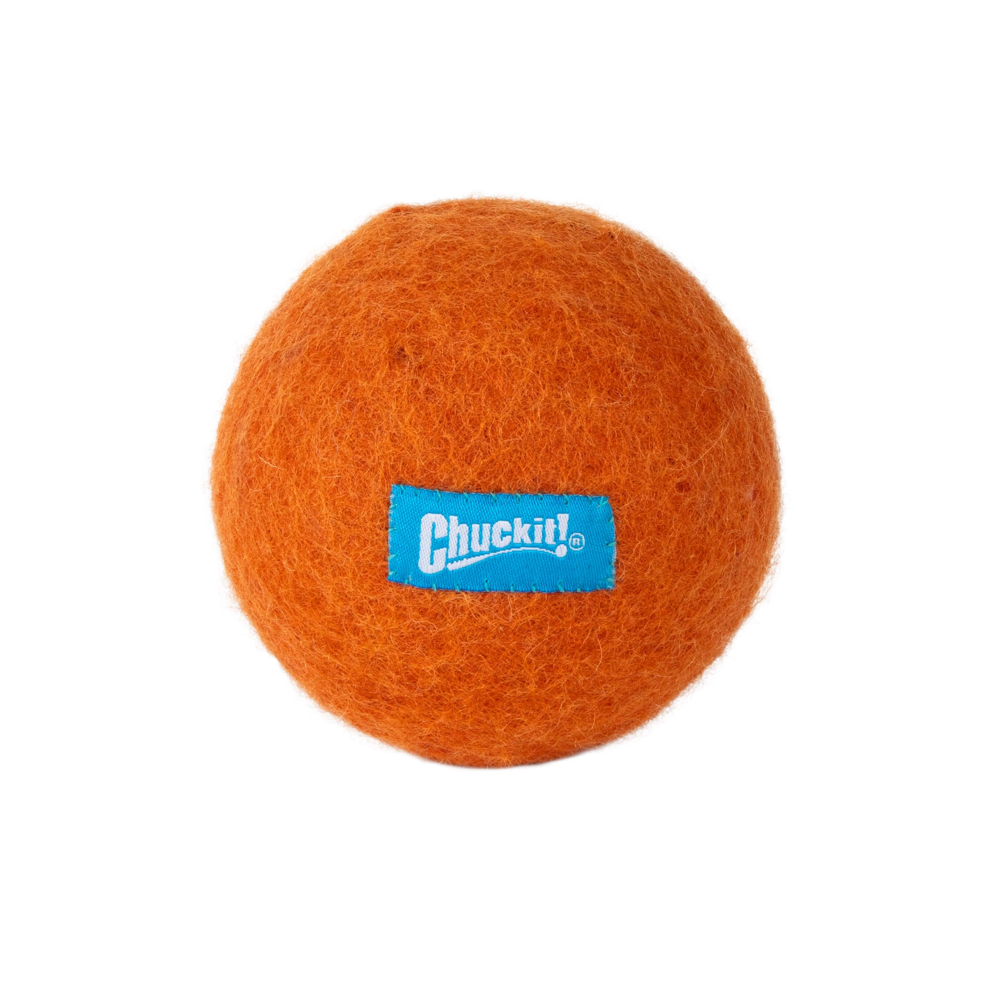 A Chuckit! Wool-ee Ball dog toy, orange and fuzzy with a blue Chuckit! label, is shown on a white background—an eco-friendly toy made from natural wool.