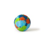 The Chuckit! EcoFetch Recycled Rubber Fetch Ball Medium, from Chuckit, features a textured surface with blue, green, and orange patches resembling an artistic globe. Made from eco-friendly recycled rubber and compatible with Chuckit! Launchers, it casts a soft shadow on its white backdrop.