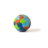 The Chuckit! EcoFetch Recycled Rubber Fetch Ball Medium, crafted from recycled rubber, features blue, green, red, and orange splotches. The Chuckit brand name is embossed on its surface. Ideal for Chuckit Launchers, it is showcased against a plain white background.