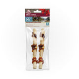Two Wild Eats Water Buffalo Twisted Cheek dog chews with natural ingredients are grain-free and labeled Free Range. The clear package reveals the contents, featuring a red bow and mountain scenery, suggesting a premium or gift item.
