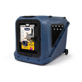 Petmate Basecamp Travel Kennel: a durable blue plastic hard-shell crate for large dogs with a black wire front door, side air vents, and rear wheels for travel.