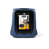 Blue plastic Petmate Basecamp Travel Kennel with a black metal grated door and an informational product label attached to the front.