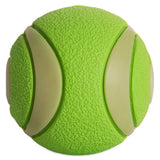 The Chuckit Max Glow Ultra Squeaker Ball by Chuckit boasts a vibrant green color with a textured surface and smooth beige curved panels, perfect for endless fetch play.