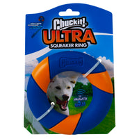 The Chuckit Ultra Squeaker Ring packaging features durable Ultra rubber in vibrant blue and orange with a white leash. A happy dog illustration and It squeaks! text are set against a green grassy backdrop and blue sky, pairing well with the Chuckit RingChaser Launcher.
