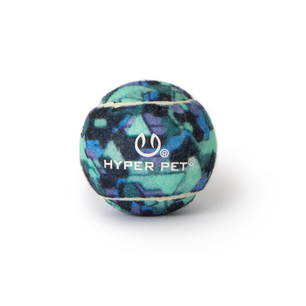 The Hyper Pet Camo Tennis Ball 4 Pack by Hyperpet features a multicolored camo pattern in blue, green, and purple with Hyper Pet and a smiling face logo printed on it. Designed for professional-grade use with the K9 Kannon.