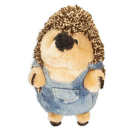The Zoobilee Farmer Heggies Dog Toy is a cuddly plush hedgehog dressed in blue denim overalls. Its soft beige fur and textured dark brown back resemble spikes, while its small black nose and eyes add to its adorable charm.