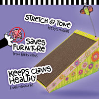 The FAT CAT Big Mamas Scratch N Play Ramp by Fatcat, made from brown corrugated material, rests on a lavender background with colorful flowers. Key benefits include Stretch & Tone, Saves Furniture, and Keeps Claws Healthy. Its infused with Big Mamas Catnip and is 100% eco-friendly recyclable.