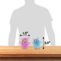 Two small, colorful toy creatures sit on a wooden surface. The pink one is 1.3 inches tall, and the blue stands at 3.9 inches. Modeled after Fatcats FAT CAT Classic Fluff Bunnies Cat Toy, they are posed in front of a silhouette for size reference, ready to zoom around in playful adventures.