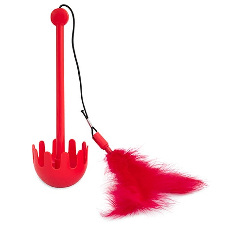 The JW Swatical Cat Toy by Jw features a red plastic back scratcher with a rounded handle, a detachable black elastic strap, and a paw-powered feathered tickler resembling cat play, all attached by a metal hook.
