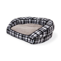 Introducing the La-Z-Boy Tucker Plaid Sofa: a pet bed with high, rounded sides and a soft, beige cushion. Its black and white checkered pattern, filled with ComfortSelect fiberfill, is perfect for medium-sized dogs seeking a cozy spot.