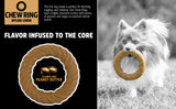 A fluffy dog holds a BarkBone Natural Instinct Peanut Butter Infused Nylon Chew Ring in its mouth. The allergen-free chew, perfect for tough chewers, is durable, textured, and playful.