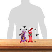 The FAT CAT Classic Appeteasers from Fatcat include two plush mice-shaped cat toys on a wooden surface. One is purple with Halloween decorations and Zoom Around the Room® organic catnip, measuring 1.3 inches wide, and the red one stands 4 inches tall with a silhouette for scale.